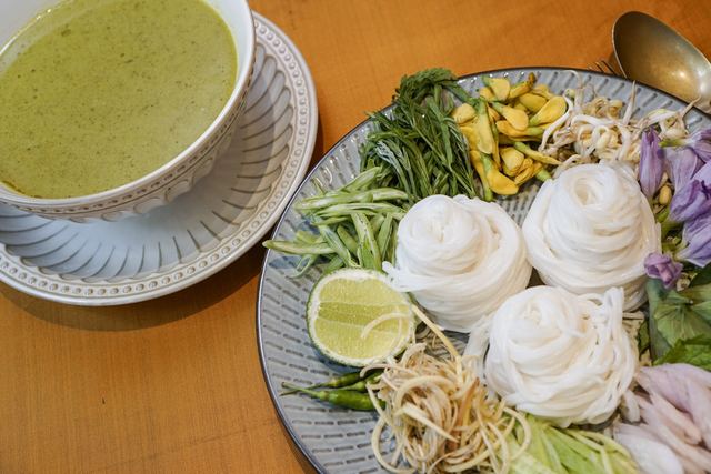 Num banh chok at Kravanh: coils of rice noodles with herbs, banana flower and a bowl of green fish curry